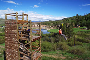 zipline a man in a red shirt cruising down the zipline